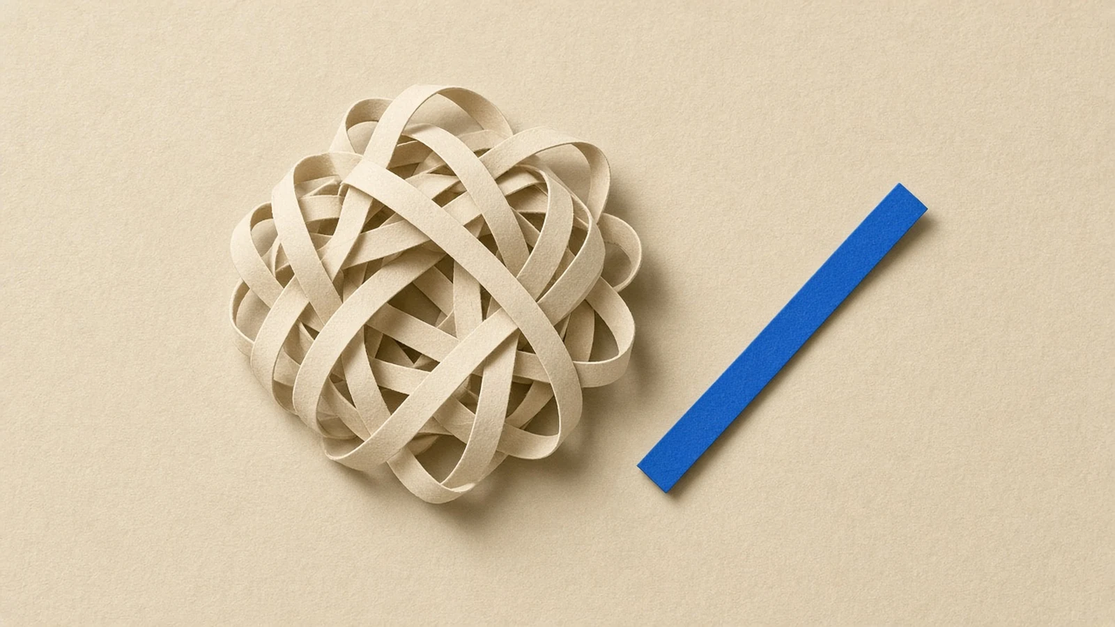 Tangled cream paper strips with one straight blue strip running cleanly through them