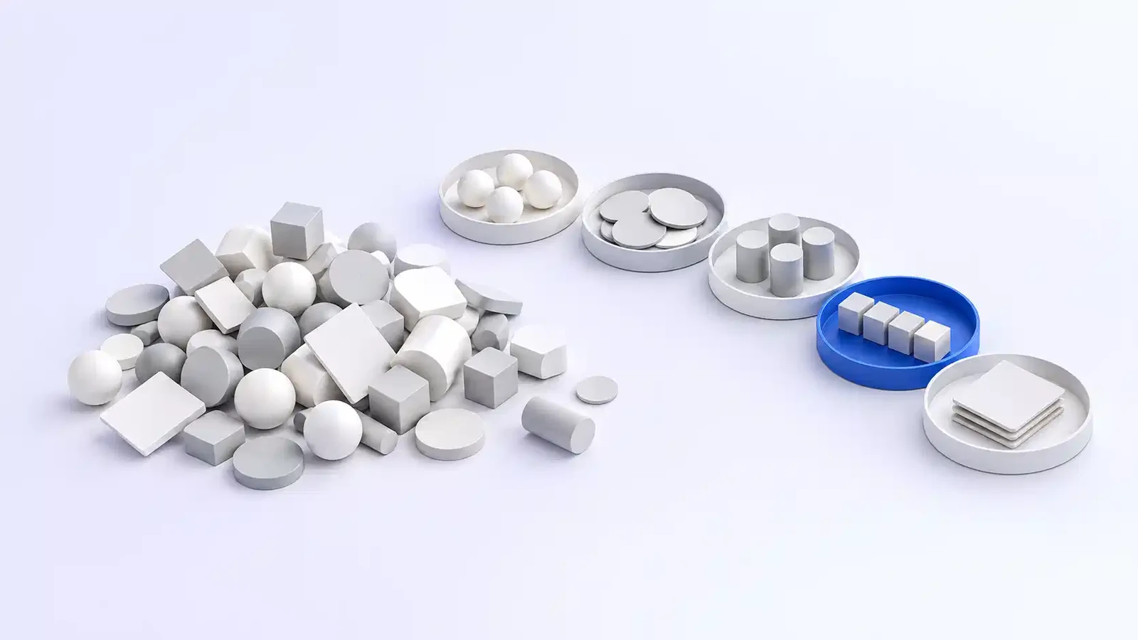 A loose heap of mixed shapes beside five small trays, each holding one kind of shape, with the cubes in the blue tray standing in a neat line.
